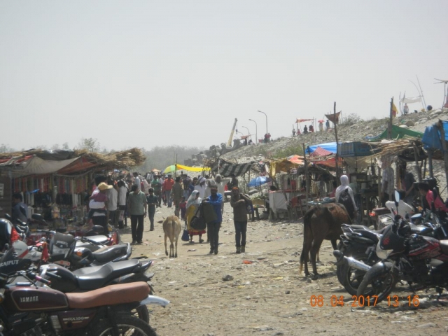 People lining up in Brahmdeo Market along the shard left bund